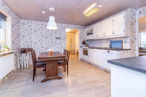 a kitchen and dining room with a table and chairs at VGO959-Kalv-Gunnarpsvaegen-3 in Kalv