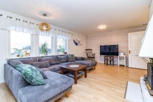 a living room with a couch and a tv at VGO959-Kalv-Gunnarpsvaegen-3 in Kalv