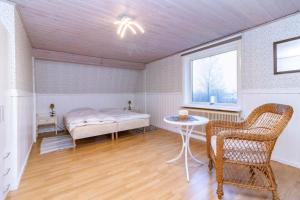 a bedroom with a bed and a table and a window at VGO959-Kalv-Gunnarpsvaegen-3 in Kalv