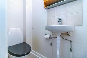 a white bathroom with a toilet and a sink at VGO959-Kalv-Gunnarpsvaegen-3 in Kalv +8 photos