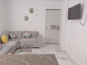 a living room with a couch and a tv at Ocean Glips II in Punta Negra