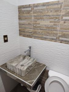 a bathroom with a sink and a toilet in it at Ocean Glips II in Punta Negra +16 photos