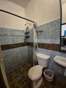 a bathroom with a toilet and a sink at Hotel Eco Point in Minca