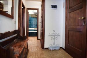 a hallway with a wooden bench and a door at Ca Maria Celeste Apartment in Bellagio +15 photos