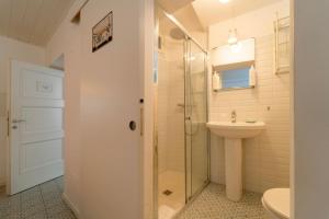 a bathroom with a sink and a shower and a toilet at Loving Loppia - Glicine in Bellagio +13 photos