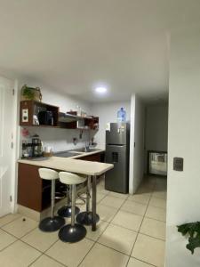 a kitchen with a table and a refrigerator at Arena Marina-Sol l in El Cerrillo