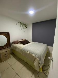 a bedroom with a bed with a mirror and a dresser at Arena Marina-Sol l in El Cerrillo