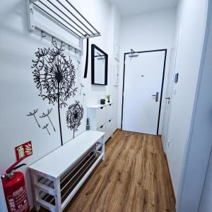 a white room with a bench on the wall at B-point apartments in Komárov