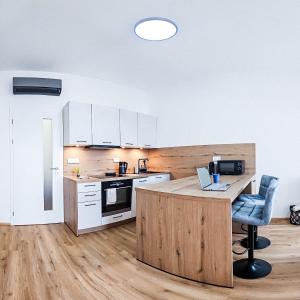a kitchen with a desk with a laptop on it at B-point apartments in Komárov