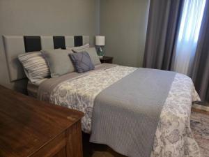 a bedroom with a large bed with pillows on it at Modern Victorian by Beach and Forest Unit B in Crescent City