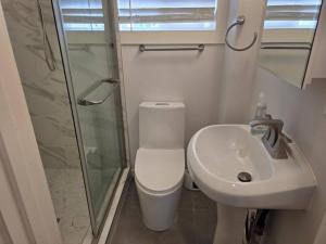 a small bathroom with a toilet and a sink at Modern Victorian by Beach and Forest Unit B in Crescent City +9 photos