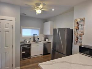 a kitchen with a stainless steel refrigerator and a ceiling fan at Modern Victorian by Beach and Forest Unit B in Crescent City