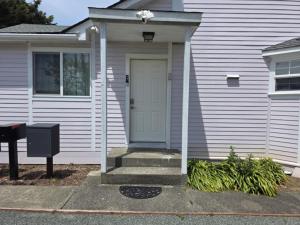 a white house with a white door and stairs at Modern Victorian by Beach and Forest Unit B in Crescent City