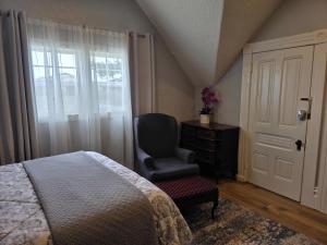 a bedroom with a bed and a chair and a window at Modern Victorian by Beach and Forest Unit C in Crescent City +7 photos