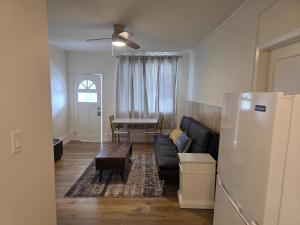 a living room with a couch and a refrigerator at Modern Victorian by Beach and Forest Unit D in Crescent City