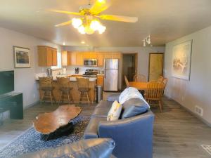 a living room with a blue couch and a kitchen at The Hofer Beach Retreat in Crescent City