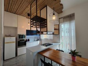 a kitchen with a wooden table and a dining room at Superior Apartment Near Beach in Chania