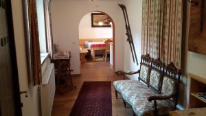 a hallway with a couch and a dining room at Haus Bellevue in Obertraun