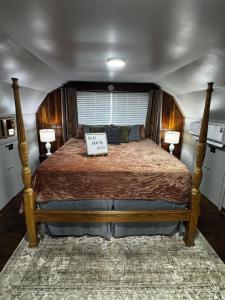 a bedroom with a large bed with a sign on it at Meadowview Guest House in Hillsboro +18 photos
