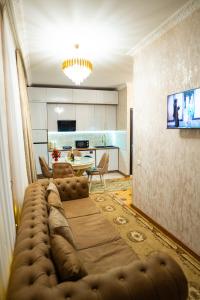a living room with a couch and a kitchen at Ala's Old District in Kutaisi