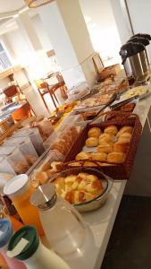 a buffet line with various pastries and other pastries at Antonio's Hotel e Spa - Airport in Brasília