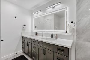 a bathroom with a sink and a large mirror at 4BR Mesa Basecamp, Mins to Cubs Spring Training in Mesa +30 photos
