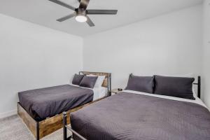 a bedroom with two beds and a ceiling fan at 4BR Mesa Basecamp, Mins to Cubs Spring Training in Mesa