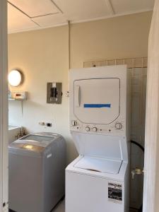 a washing machine and a washer and dryer in a room at Patch&Porch Cottage in Port Antonio