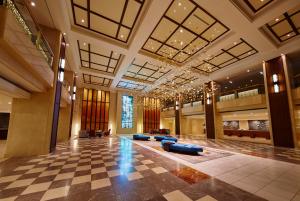 a lobby with couches and a checkered floor at Shinagawa Prince Hotel in Tokyo