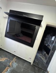 a fire place in a wall with a fireplace at AP FRENTE MAR Compacto, Completo e Confortável in São Vicente +4 photos
