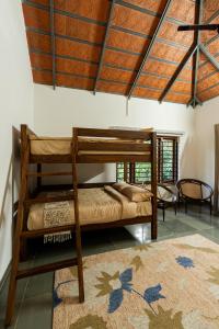 a bedroom with two bunk beds and a rug at 1st Miracle By Mirth, Mythadi , Coorg in Ammatti +68 photos