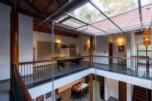 an open living room with a balcony with a large window at 1st Miracle By Mirth, Mythadi , Coorg in Ammatti