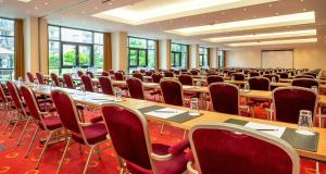 a large room with rows of tables and chairs at Victor's Residenz-Hotel Berlin Mitte in Berlin