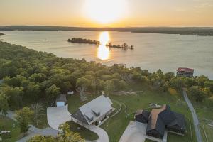an aerial view of a house on a island in the water at Upscale A-Frame Escape w/ Lake Access in Quinton! in Quinton