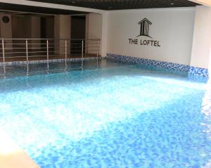 a swimming pool with blue water in a hotel at Carl's Peace Haven in Gachie