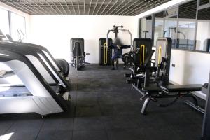 a gym with several treadmills and exercise bikes at Carl's Peace Haven in Gachie