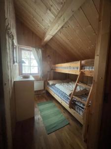 a bedroom with bunk beds in a wooden cabin at The View - Mountain cabin with stunning views in Stranda