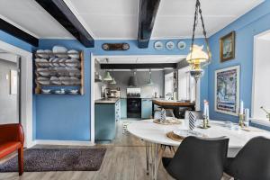 a kitchen and dining room with blue walls at AE315-Marstal-Kongensgade-8 in Marstal