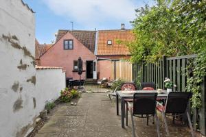 a patio with a table and chairs and a fence at AE315-Marstal-Kongensgade-8 in Marstal +17 photos