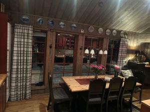 a dining room with a wooden table and chairs at The View - Mountain cabin with stunning views in Stranda
