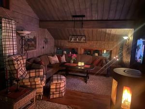 a living room with a couch and a table at The View - Mountain cabin with stunning views in Stranda