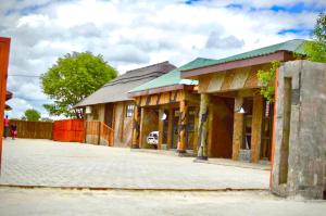 a building with a fence in front of it at Makgadikgadi Riverview Inn in Nata +17 photos