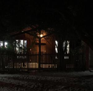a house with a gate with a light at night at Casa Da MAELA in Corumbau