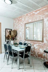a dining room with a table and chairs at Country house, peace comfort & love in Contagem