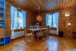 a dining room with a table and chairs in a cabin at BLE876-Holmsjoe-Husgoel-216 in Holmsjö