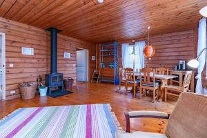 a living room with a table and a fireplace at BLE876-Holmsjoe-Husgoel-216 in Holmsjö