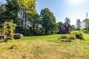 an empty yard with a house in the background at BLE876-Holmsjoe-Husgoel-216 in Holmsjö +10 photos