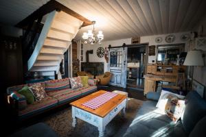 a living room with a couch and a table at Drevenička Modruška in Malý Čepčín