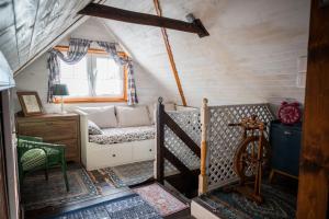 a room with a bed in a tiny house at Drevenička Modruška in Malý Čepčín