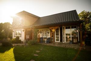 a house with a green lawn in front of it at Drevenička Modruška in Malý Čepčín